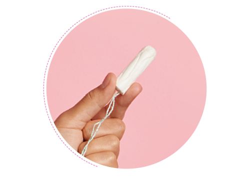 A hand holding a clean tampon against a pink backdrop.